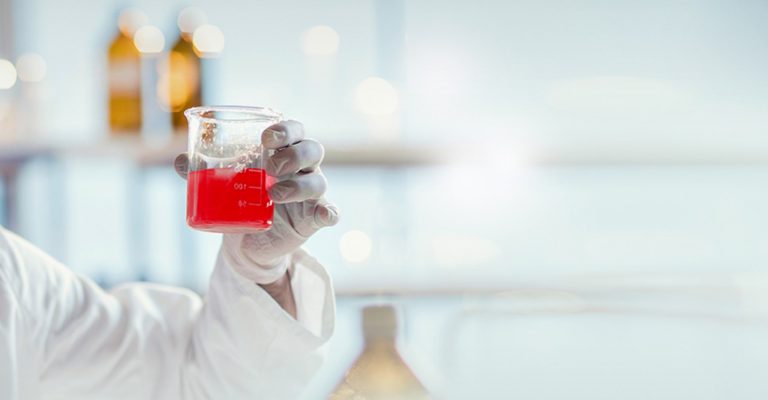 Scientist Holding Beaker of Media