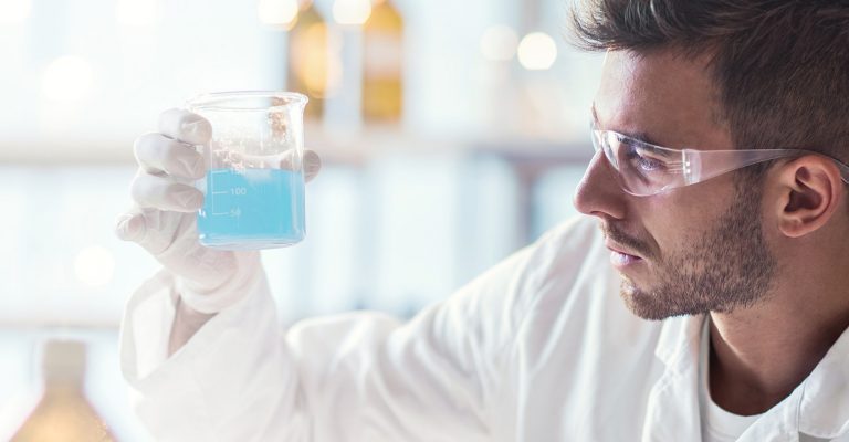 Scientist holding up a pyrex beaker