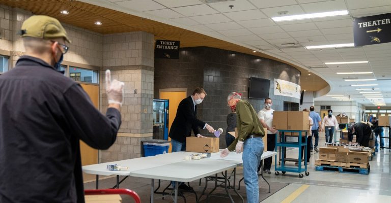 People preparing to distribute food