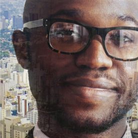 Montage: man in glasses, aerial of large city in background