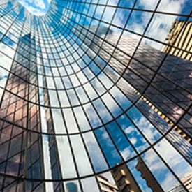 Looking up at hundreds of windows in building's concave structure