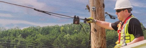 Man working on a telecommunications pole