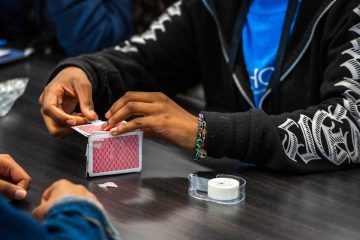 Students in the engineering session building a sturdy structure using playing cards and tape.